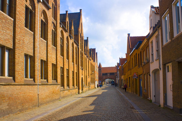 BELGIUM, BRUGGE - May 3, 2019: Medieval street of Old Brugge - Zdjęcie, obraz
