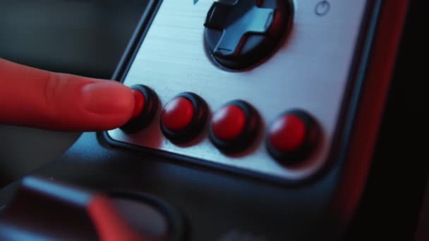 Close-up of the hands of a young gamer behind the steering wheel of a racing simulator and push buttons. Young gamer enjoying car racing video game with a wheel. Computer simulation. - Materiał filmowy, wideo