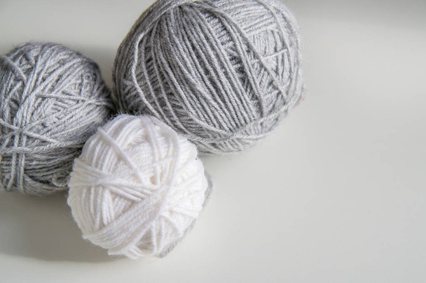 three ball of wool yarn for knitting, gray ball of yarn, white ball of yarn on white background - Foto, afbeelding