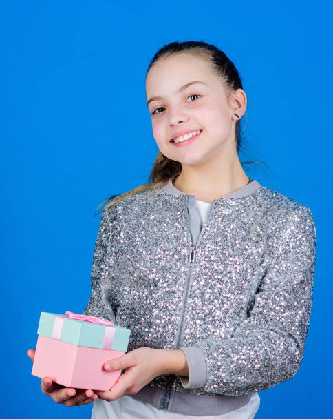 Black friday. Shopping day. Cute adorable child carry gift box. Surprise gift box. Birthday wish list. World of happiness. Special happens every day. My precious. Girl with gift box blue background - Foto, Bild
