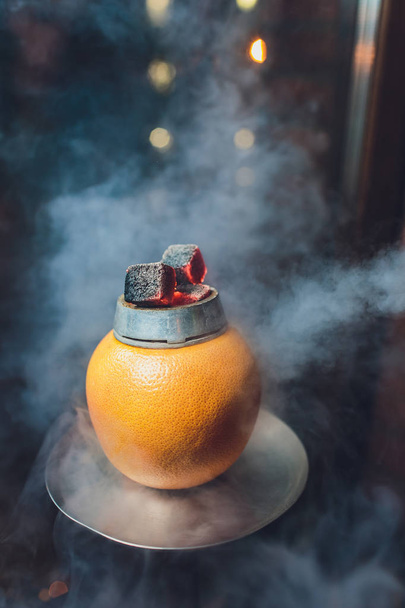 Stylish hookah with aroma grapefruit for relax. grapefruit shisha. Hookah lounge. - 写真・画像