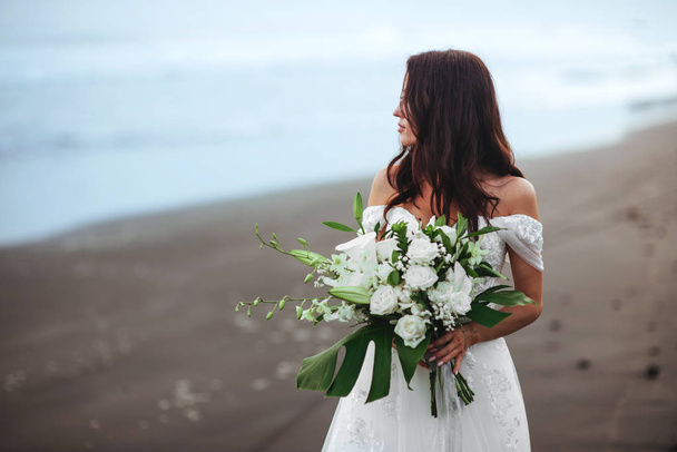Bride on a beach in the blue water - Фото, зображення