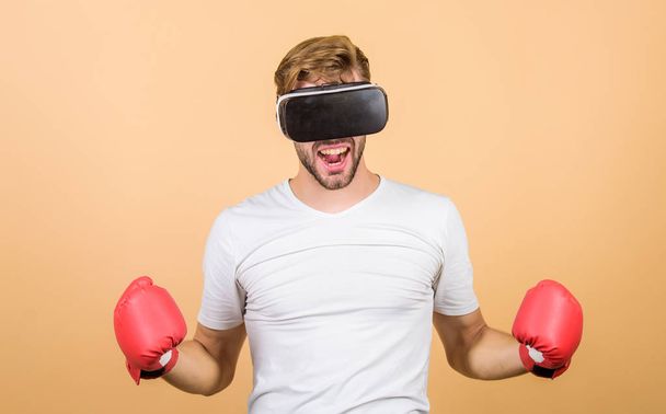 Cyber coach online training. Explore cyber space. Cyber sportsman boxing gloves. Man play game in VR glasses. Cyber sport concept. Augmented 3D world. Man boxer virtual reality headset simulation - Foto, Imagen