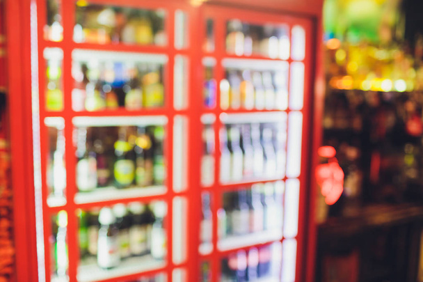 Blur of bottles of beer alcohol drink on Shelf in Supermarket Background.for alcohol drink market concept. - Fotografie, Obrázek