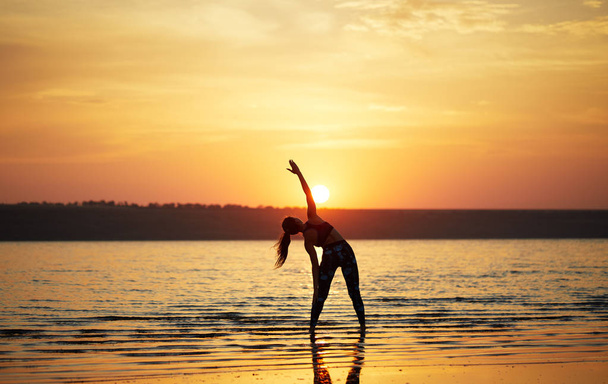 Yoga et fitness. Jeune femme pratiquant la méditation matinale dans la nature à la plage
 - Photo, image