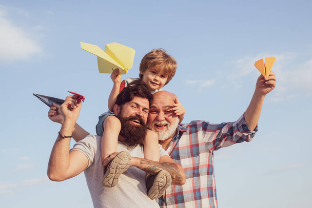 Family generation: future dream and people concept. Boy with father and grandfather. Father son and grandfather relaxing together. Multi generation. Generations men. - Zdjęcie, obraz
