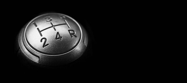 Close up view of a manual gear lever shift isolated on black background. Manual gearbox. Car interior details. Car transmission. Soft lighting. Abstract view. Car detailing - Photo, image