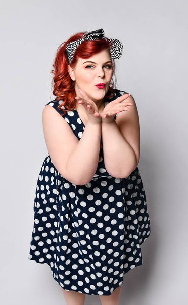 Pin up woman portrait. Beautiful retro female in polka dot dress with red lips and manicure nails and old fashion hairstyle - Foto, Imagem