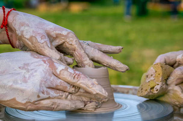 Creating a sculpture of clay close-up. Hands making products fro - Photo, Image