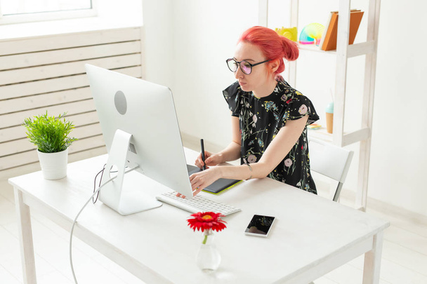 Business, suunnittelija ja animaattori käsite nuori nainen kuvittaja tai taiteilija vaaleanpunaiset hiukset piirtää graafinen tabletti
 - Valokuva, kuva