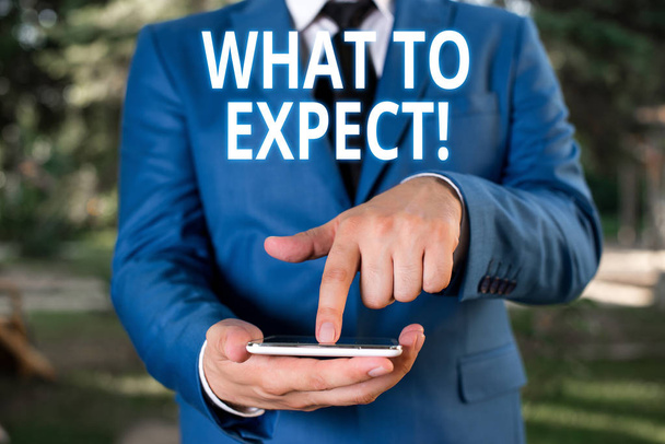 Writing note showing What To Expect. Business photo showcasing asking about regard something as likely to happen occur Businessman with pointing finger in front of him. - Photo, Image