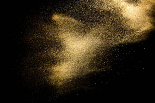 Sand explosion isolated on black background. Freeze motion of sandy dust splash. - Photo, Image