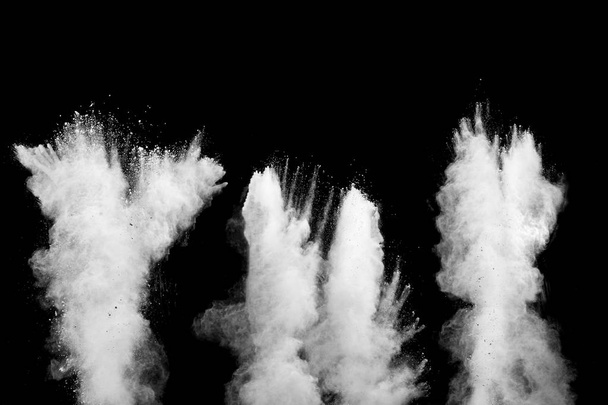 White talcume powder explosion on black background. White dust particles splash. - Photo, Image