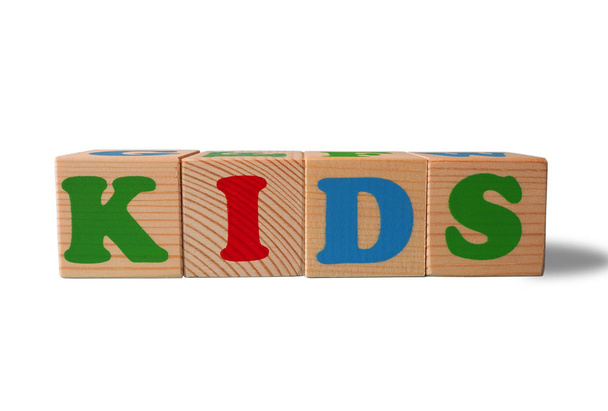 Wooden alphabet toy blocks with the text: Kids. Isolated kids ABC cubes on white background with copy space for your design.  - Photo, Image