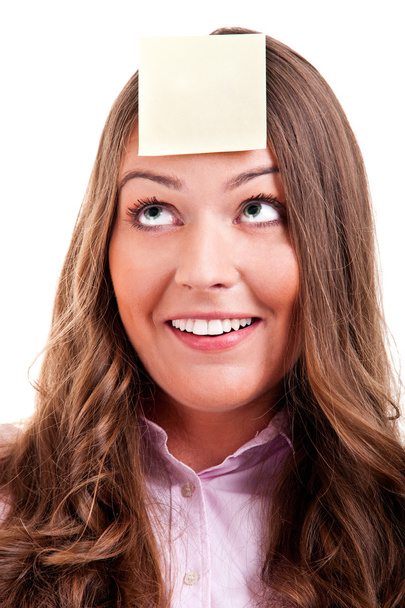 Young woma with yellow sticky note on forehead - Foto, Bild