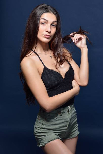 Beautiful woman in a black top and shorts - Фото, изображение