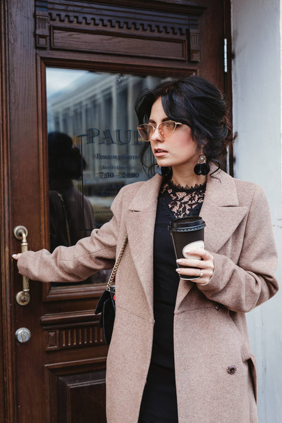 Pretty young woman on the city street with mobile phone and coffee - Foto, immagini
