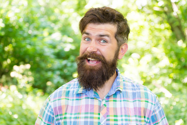Summer vacation concept. Man bearded hipster green trees background. Hike and travel. Guy relax in summer nature. United with environment. Handsome lumberjack. Man beard and mustache in summer forest - Fotoğraf, Görsel