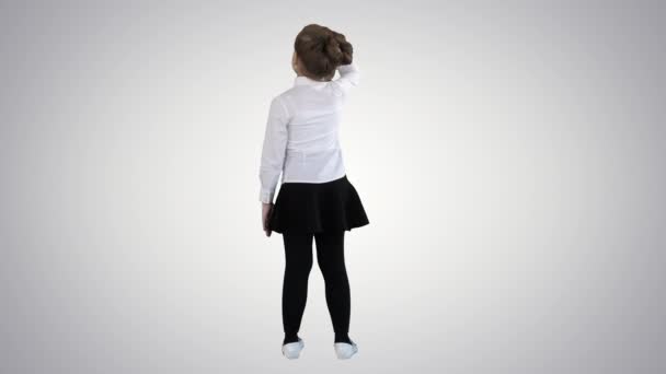 Little girl looking away on gradient background. - Footage, Video