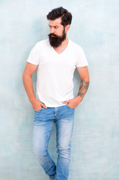 Casual style daily life. Simple and casual. Masculinity concept. Fashion and beauty. Hipster long well groomed beard and mustache. Male temper brutality. Brutal macho casual outfit gray background - Zdjęcie, obraz