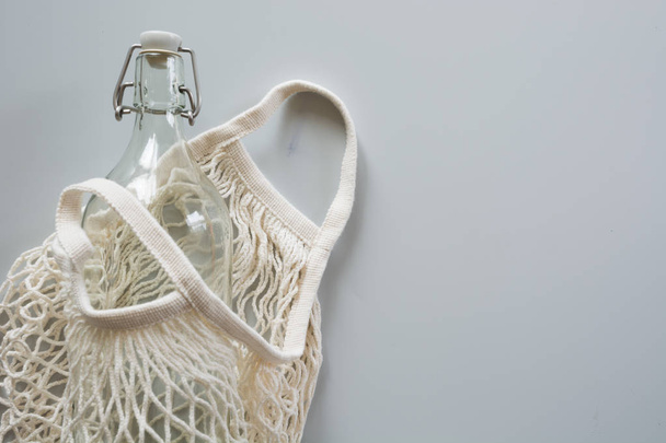 Eco natural textile mesh bag with metal and glass bottle for reuse.Sustainable lifestyle concept. Zero waste, plastic free. Pollution environment. - 写真・画像