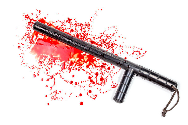 Bloody russian police rubber tonfa baton in blood spatter isolated on white background in top-down flat lay perspective. - Photo, Image