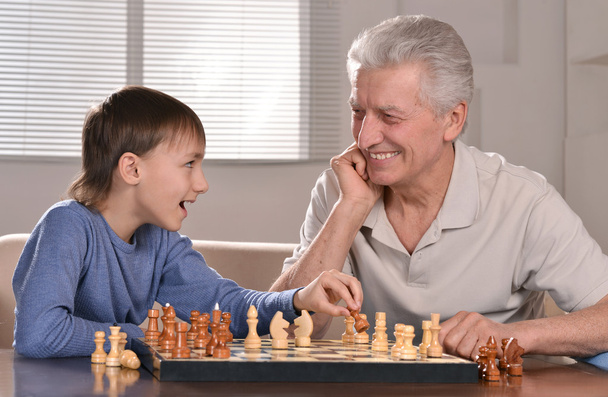 Boy and grandfather playing chess - Φωτογραφία, εικόνα