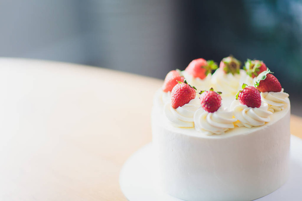Sweet cake with strawberries on plate on wooden background. - Zdjęcie, obraz