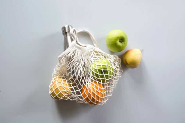 Zero waste concept. Modern shopping textile bag with fruits and vegetables. Top view. - Fotó, kép
