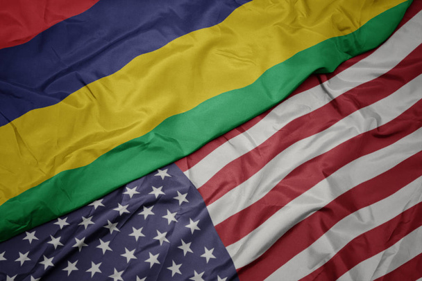 waving colorful flag of united states of america and national flag of mauritius. - Fotó, kép