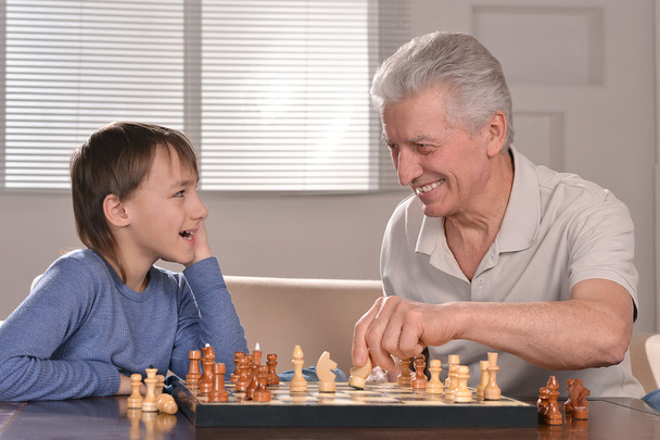Boy and grandfather playing chess - Foto, Imagem