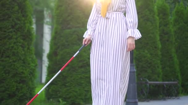 portrait of a young beautiful blind woman in a hijab with a cane outside on a Sunny day - Video