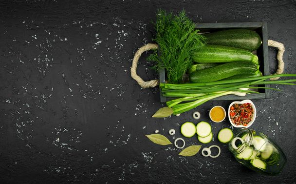 Fresh green zucchini on a dark table. The view from the top. Cop - Photo, image