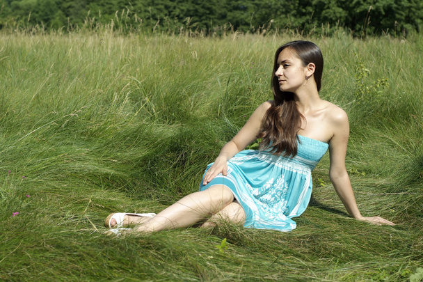 beautiful girl sitting on the grass - 写真・画像
