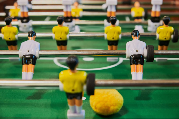 Table football, table football with close-ups of yellow and white players. - Fotografie, Obrázek