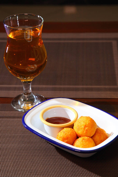 Fried balls of cheese. Cheese balls fried in breadcrumbs with sauce and wine. Deep Fried Breaded Cheese. - Photo, Image