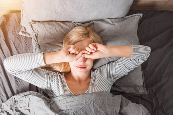 Woman stretching in bed after wake up - Photo, Image