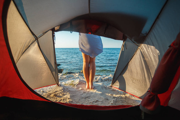 View from the tent to the sea. Girl's legs - Photo, Image