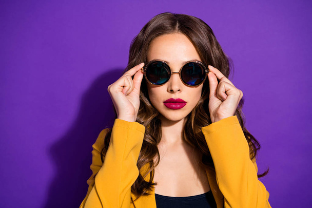 Photo of cool astonishing girl watching into camera through sunglass while being isolated with purple background - Φωτογραφία, εικόνα