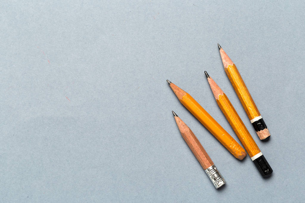 Well worn yellow pencils on light gray background  - Photo, Image