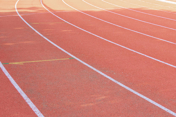 running track red outdoor with white lines and morning sunlight  - Photo, Image