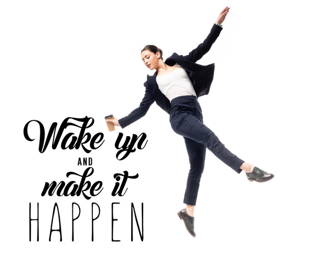 young businesswoman holding coffee to go and dancing near wake up and make it happen lettering isolated on white - Photo, Image