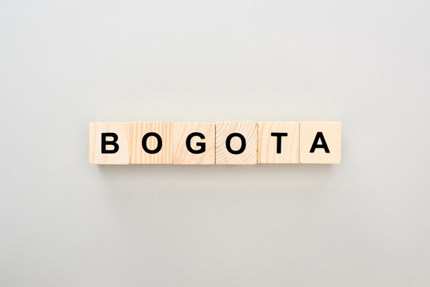 top view of wooden blocks with Bogota lettering on grey background - Foto, afbeelding