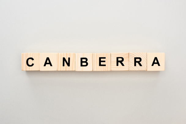 top view of wooden blocks with Canberra lettering on grey background - Photo, image