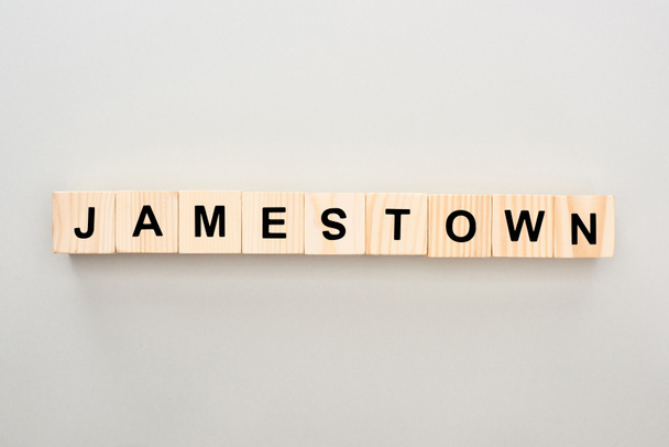top view of wooden blocks with Jamestown lettering on grey background - Fotó, kép