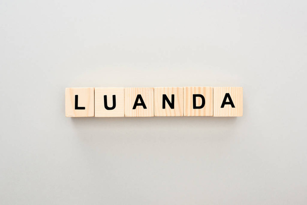 top view of wooden blocks with Luanda lettering on grey background - Foto, immagini