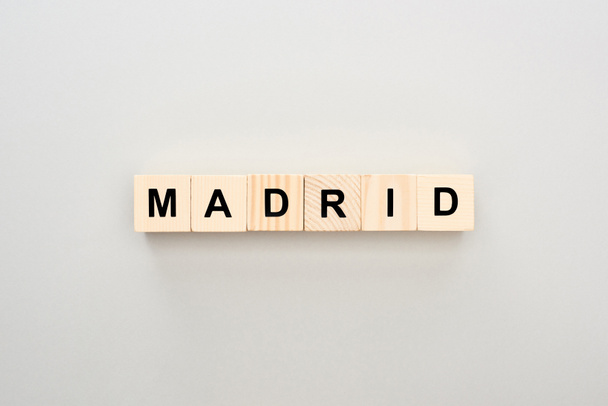 top view of wooden blocks with Madrid lettering on grey background - Photo, Image