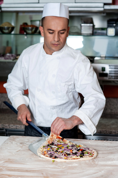 Chef busy in preparing pizza - 写真・画像