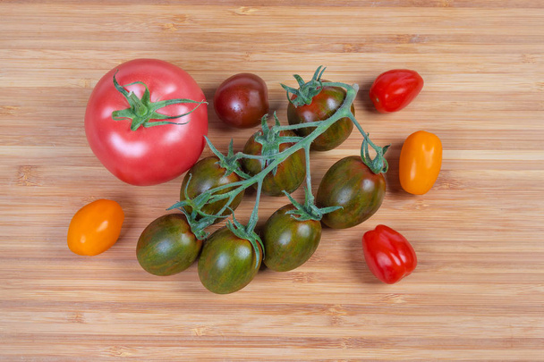 Top view of different cherry tomatoes and ordinary tomato  - Photo, Image