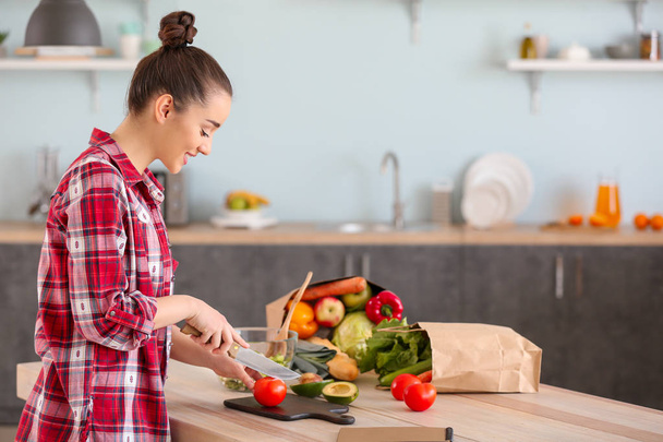 красива жінка готує смачний овочевий салат на кухні вдома
 - Фото, зображення